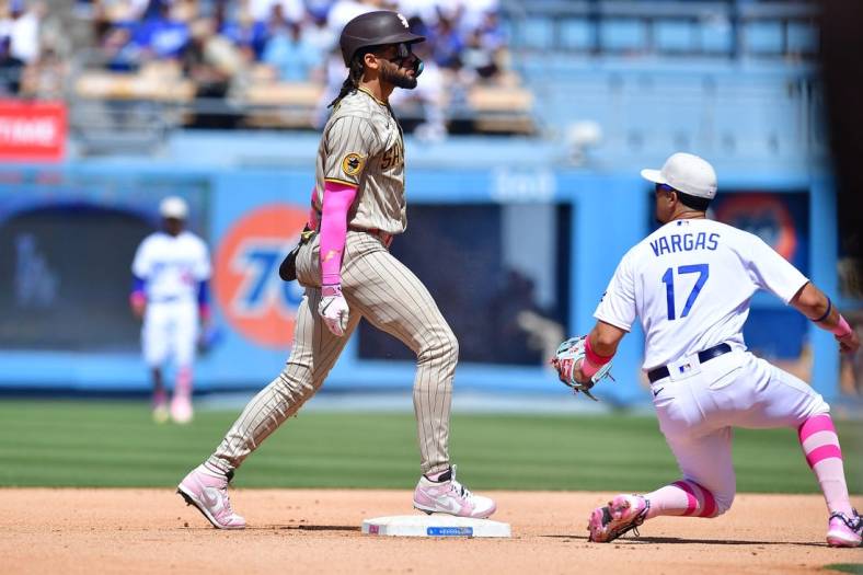 May 14, 2023; Los Angeles, California, USA; San Diego Padres right fielder Fernando Tatis Jr. (23) steals second against Los Angeles Dodgers second baseman Miguel Vargas (17) during the eighth inning at Dodger Stadium. Mandatory Credit: Gary A. Vasquez-USA TODAY Sports