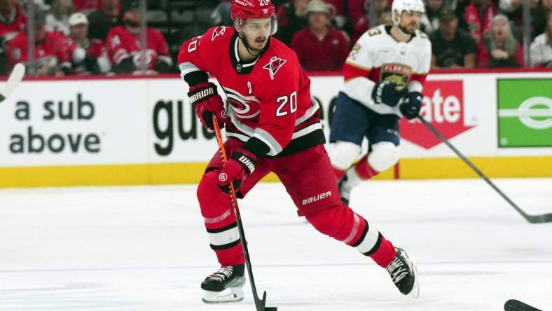 May 20, 2023; Raleigh, North Carolina, USA; Carolina Hurricanes center Sebastian Aho (20) pushes the puck up the ice against the Florida Panthers in game two of the Eastern Conference Finals of the 2023 Stanley Cup Playoffs at PNC Arena. Mandatory Credit: James Guillory-USA TODAY Sports