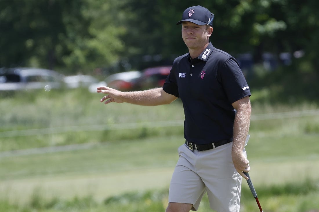 May 25, 2023; Washington, DC, USA; Talor Gooch waves to fans after making a putt on the second hole during the first round of the LIV Golf DC 2023 tournament at Trump National Golf Club in Sterling, Va. Mandatory Credit: Geoff Burke-USA TODAY Sports