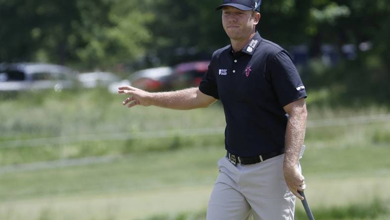 May 25, 2023; Washington, DC, USA; Talor Gooch waves to fans after making a putt on the second hole during the first round of the LIV Golf DC 2023 tournament at Trump National Golf Club in Sterling, Va. Mandatory Credit: Geoff Burke-USA TODAY Sports