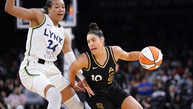 May 28, 2023; Las Vegas, Nevada, USA; Las Vegas Aces guard Kelsey Plum (10) drives the ball against Minnesota Lynx forward Napheesa Collier (24) during the third quarter at Michelob Ultra Arena. Mandatory Credit: Lucas Peltier-USA TODAY Sports