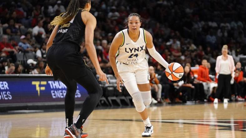 May 28, 2023; Las Vegas, Nevada, USA; Minnesota Lynx forward Napheesa Collier (24) dribbles the ball against Las Vegas Aces center Kiah Stokes (41) during the second quarter at Michelob Ultra Arena. Mandatory Credit: Lucas Peltier-USA TODAY Sports