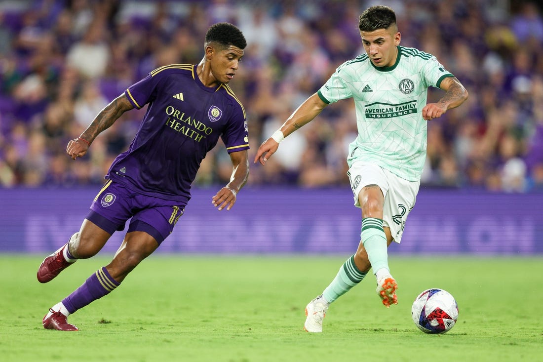 May 27, 2023; Orlando, Florida, USA;  Atlanta United FC midfielder Thiago Almada (23) controls the ball from Orlando City SC midfielder Wilder Cartagena (16) in the first half at Exploria Stadium. Mandatory Credit: Nathan Ray Seebeck-USA TODAY Sports