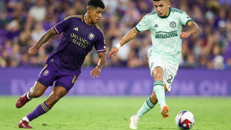 May 27, 2023; Orlando, Florida, USA;  Atlanta United FC midfielder Thiago Almada (23) controls the ball from Orlando City SC midfielder Wilder Cartagena (16) in the first half at Exploria Stadium. Mandatory Credit: Nathan Ray Seebeck-USA TODAY Sports