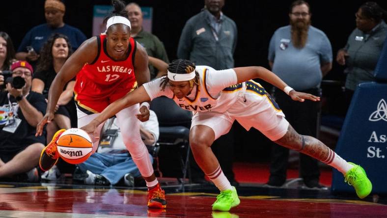 Jun 4, 2023; Indianapolis, Indiana, USA; Las Vegas Aces guard Chelsea Gray (12) and Indiana Fever forward NaLyssa Smith (1) fight for the ball in the second half at Gainbridge Fieldhouse. Mandatory Credit: Trevor Ruszkowski-USA TODAY Sports
