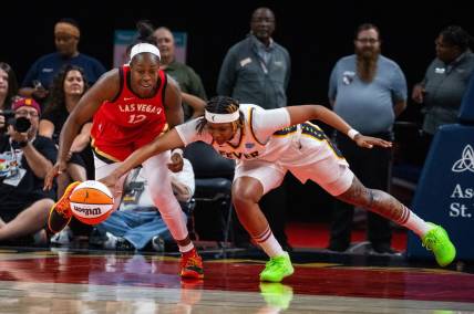 Jun 4, 2023; Indianapolis, Indiana, USA; Las Vegas Aces guard Chelsea Gray (12) and Indiana Fever forward NaLyssa Smith (1) fight for the ball in the second half at Gainbridge Fieldhouse. Mandatory Credit: Trevor Ruszkowski-USA TODAY Sports