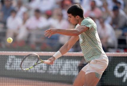 Jun 9 2023; Paris,France; Carlos Alcaraz (ESP) returns a shot during his semifinal match against Novak Djokovic (SRB) on day 13 at Stade Roland-Garros. Mandatory Credit: Susan Mullane-USA TODAY Sports