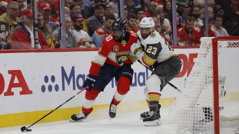 June 10, 2023; Sunrise, FL, USA; Florida Panthers left wing Anthony Duclair (10) battles for the puck against Vegas Golden Knights defenseman Alec Martinez (23) in the second period in game four of the 2023 Stanley Cup Final at FLA Live Arena. Mandatory Credit: Sam Navarro-USA TODAY Sports