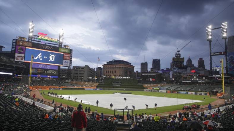 Jun 13, 2023; Detroit, Michigan, USA; The Detroit Tigers grounds crew works to put the tarp on the field during a rain delay at Comerica Park. Mandatory Credit: Brian Bradshaw Sevald-USA TODAY Sports