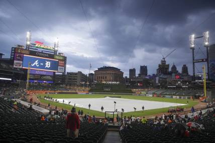 Jun 13, 2023; Detroit, Michigan, USA; The Detroit Tigers grounds crew works to put the tarp on the field during a rain delay at Comerica Park. Mandatory Credit: Brian Bradshaw Sevald-USA TODAY Sports