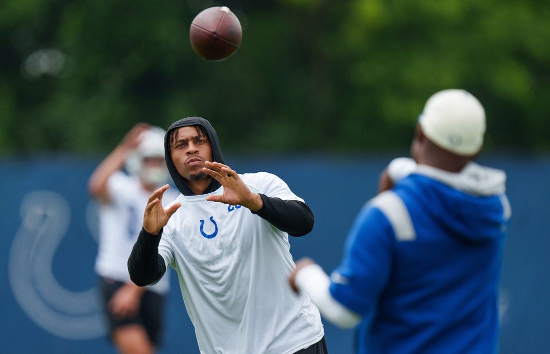 June 14, 2023; Indianapolis, IN, USA; Indianapolis Colts running back Jonathan Taylor (28) passes on the sideline Wednesday, June 14, 2023, during mandatory minicamp at the Indiana Farm Bureau Football Center in Indianapolis. Mandatory Credit: Mykal McEldowney-USA TODAY Sports