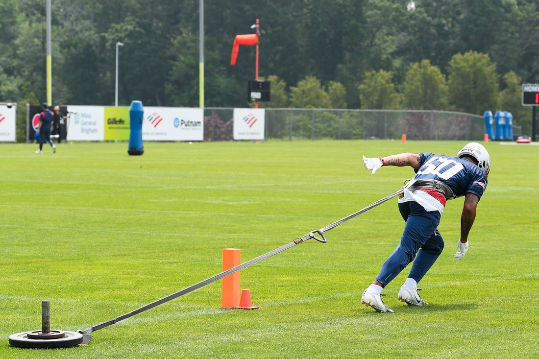 Jun 12, 2023; Foxborough, MA, USA; New England Patriots cornerback Christian Gonzalez (50) pulls a sled at the Patriots minicamp at Gillette Stadium.  Mandatory Credit: Eric Canha-USA TODAY Sports