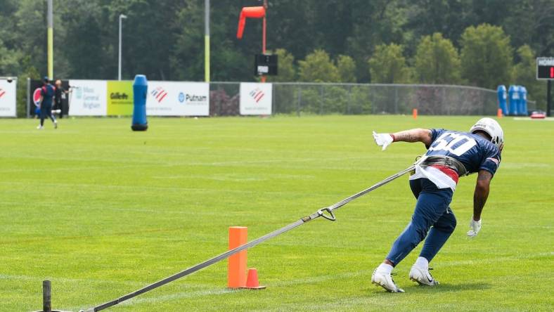 Jun 12, 2023; Foxborough, MA, USA; New England Patriots cornerback Christian Gonzalez (50) pulls a sled at the Patriots minicamp at Gillette Stadium.  Mandatory Credit: Eric Canha-USA TODAY Sports