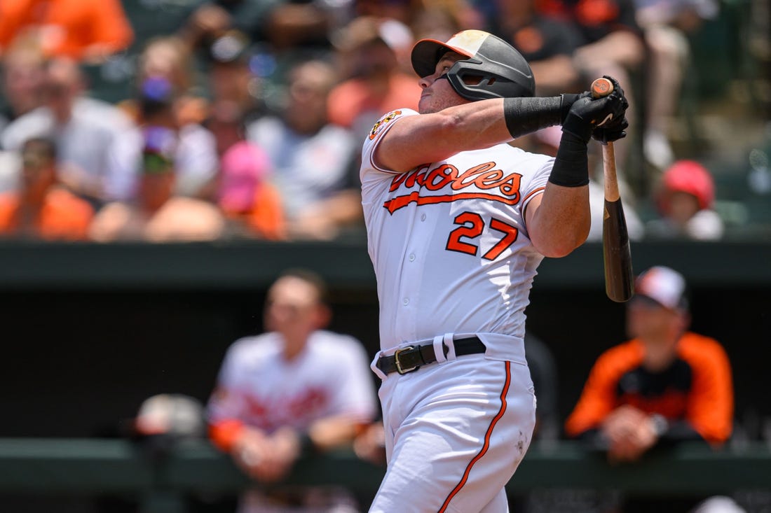 Jun 15, 2023; Baltimore, Maryland, USA; Baltimore Orioles catcher James McCann (27) hits a single during the fifth inning against the Toronto Blue Jays at Oriole Park at Camden Yards. Mandatory Credit: Reggie Hildred-USA TODAY Sports