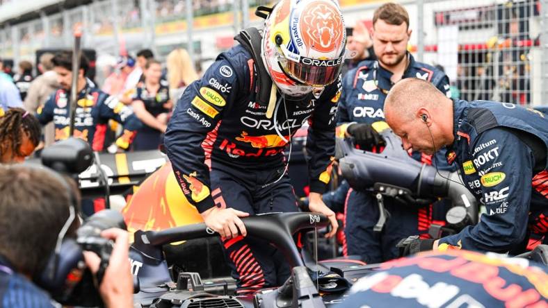 Jun 18, 2023; Montreal, Quebec, CAN; Red Bull Racing driver Max Verstappen (NED) pulls out of his car prior to the Canadian Grand Prix at Circuit Gilles Villeneuve. Mandatory Credit: David Kirouac-USA TODAY Sports