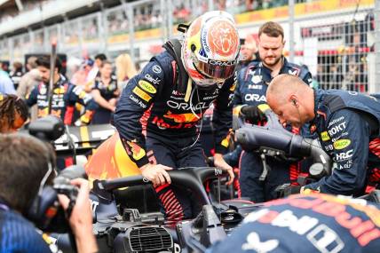 Jun 18, 2023; Montreal, Quebec, CAN; Red Bull Racing driver Max Verstappen (NED) pulls out of his car prior to the Canadian Grand Prix at Circuit Gilles Villeneuve. Mandatory Credit: David Kirouac-USA TODAY Sports
