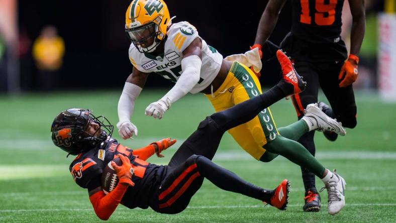 Jun 17, 2023; Vancouver, British Columbia, CAN; Edmonton Elks defensive back Dwayne Thompson II (37) tackles BC Lions receiver Alexander Hollins (13) in the first half in at BC Place. Mandatory Credit: Bob Frid-USA TODAY Sports