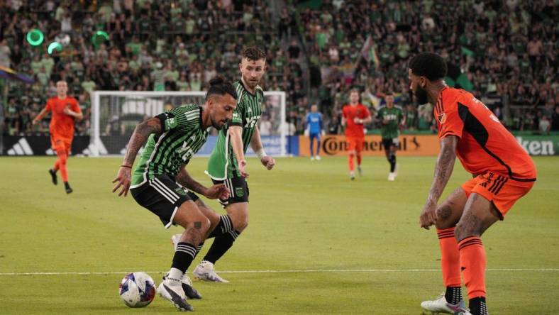 Jun 24, 2023; Austin, Texas, USA; Austin FC defender Amro Tarek (31) dribbles the ball against the Houston Dynamo defender Micael (31) during the second half at Q2 Stadium. Mandatory Credit: Dustin Safranek-USA TODAY Sports