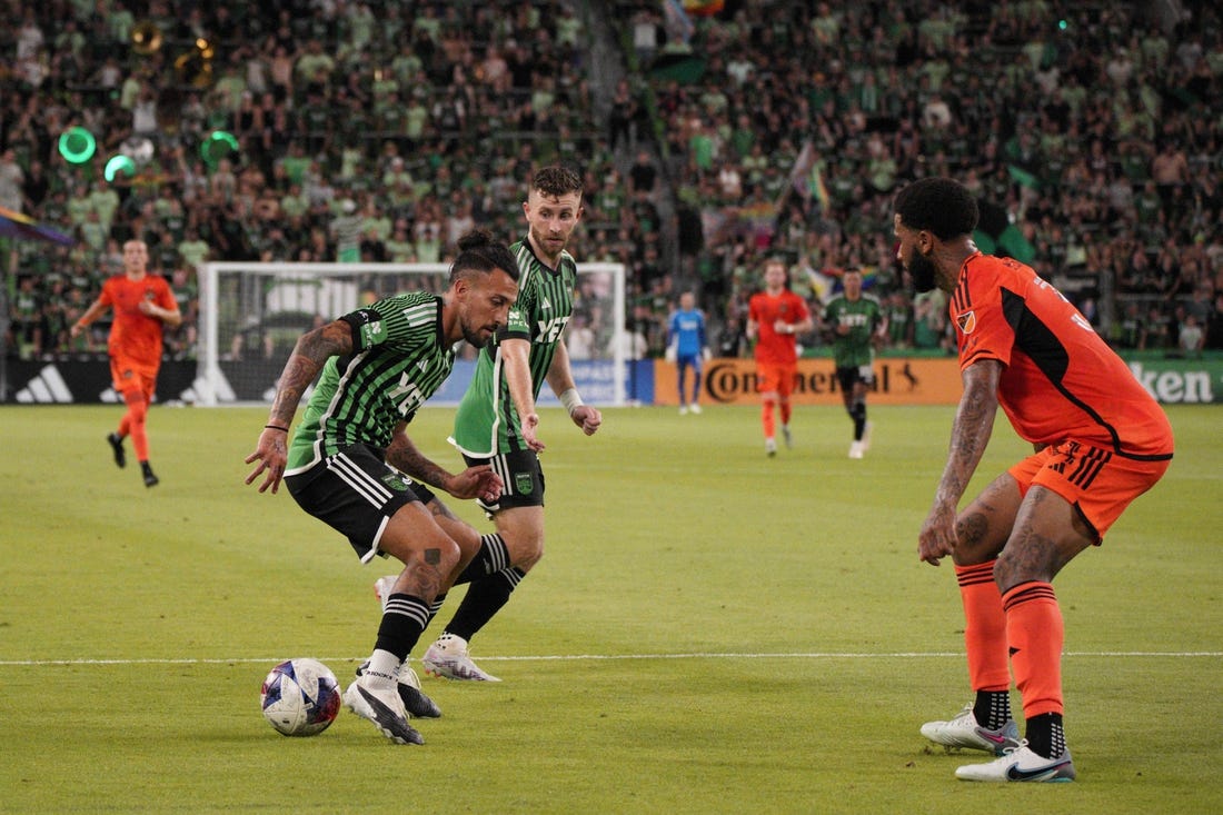 Jun 24, 2023; Austin, Texas, USA; Austin FC defender Amro Tarek (31) dribbles the ball against the Houston Dynamo defender Micael (31) during the second half at Q2 Stadium. Mandatory Credit: Dustin Safranek-USA TODAY Sports