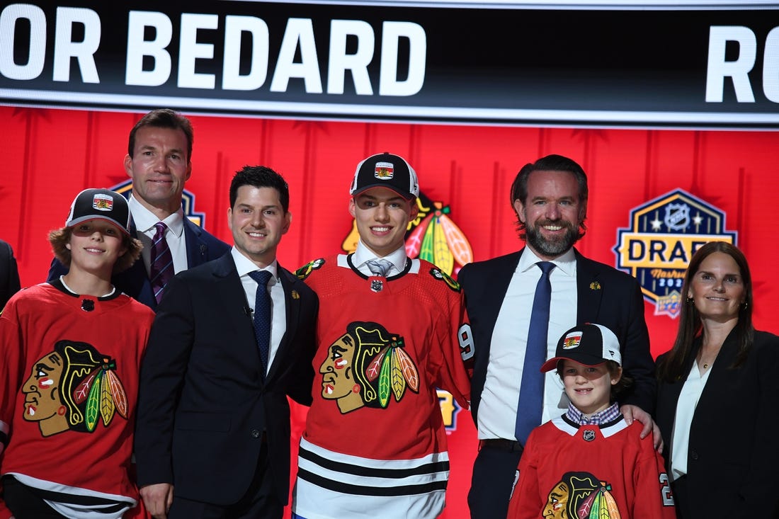 Jun 28, 2023; Nashville, Tennessee, USA; Chicago Blackhawks general manager Kyle Davidson congratulates first overall pick Connor Bedard during the 2023 NHL Draft at Bridgestone Arena. Mandatory Credit: Christopher Hanewinckel-USA TODAY Sports