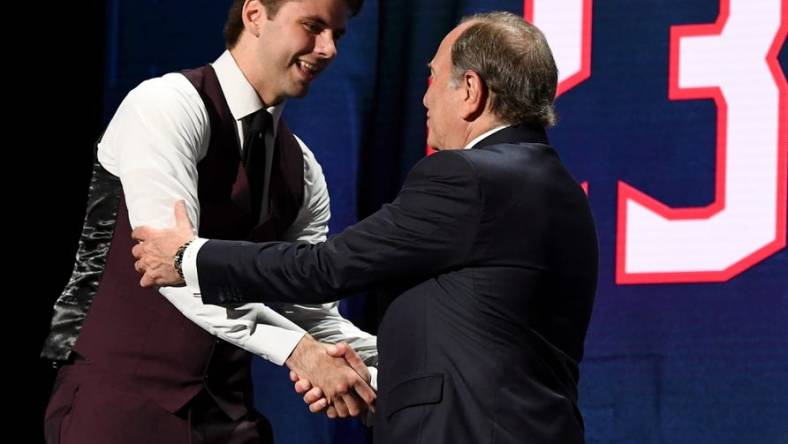 Jun 28, 2023; Nashville, Tennessee, USA; NHL commissioner Gary Bettman congratulates Columbus Blue jackets third overall pick Adam Fantilli during round one of the 2023 NHL Draft at Bridgestone Arena. Mandatory Credit: Christopher Hanewinckel-USA TODAY Sports