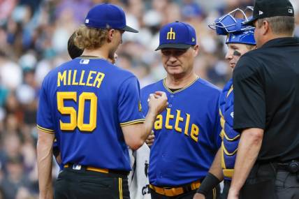 Jun 30, 2023; Seattle, Washington, USA; Seattle Mariners manager Scott Servais (middle) talks with starting pitcher Bryce Miller (50) during a potential injury analysis in the third inning against the Tampa Bay Rays at T-Mobile Park. Mandatory Credit: Joe Nicholson-USA TODAY Sports