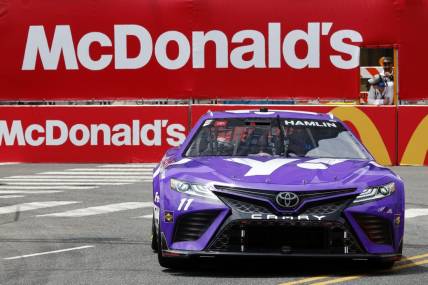 Jul 1, 2023; Chicago, Illinois, USA; NASCAR Cup Series driver Denny Hamlin (11) drives along Grant Park during practice and qualifying for the Chicago Street Race. Mandatory Credit: Mike Dinovo-USA TODAY Sports