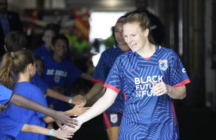 Jul 1, 2023; Seattle, Washington, USA;  OL Reign forward Veronica Latsko (24) greets fans as she walks to the field before playing against Racing Louisville FC in a NWSL game at Lumen Field. Mandatory Credit: Stephen Brashear-USA TODAY Sports