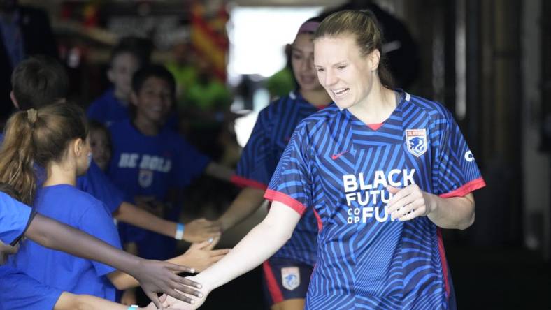 Jul 1, 2023; Seattle, Washington, USA;  OL Reign forward Veronica Latsko (24) greets fans as she walks to the field before playing against Racing Louisville FC in a NWSL game at Lumen Field. Mandatory Credit: Stephen Brashear-USA TODAY Sports