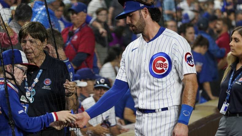 Jul 1, 2023; Chicago, Illinois, USA; Chicago Cubs shortstop Dansby Swanson (7) signs an autograph before the game between the Chicago Cubs and the Cleveland Guardians at Wrigley Field. Mandatory Credit: David Banks-USA TODAY Sports