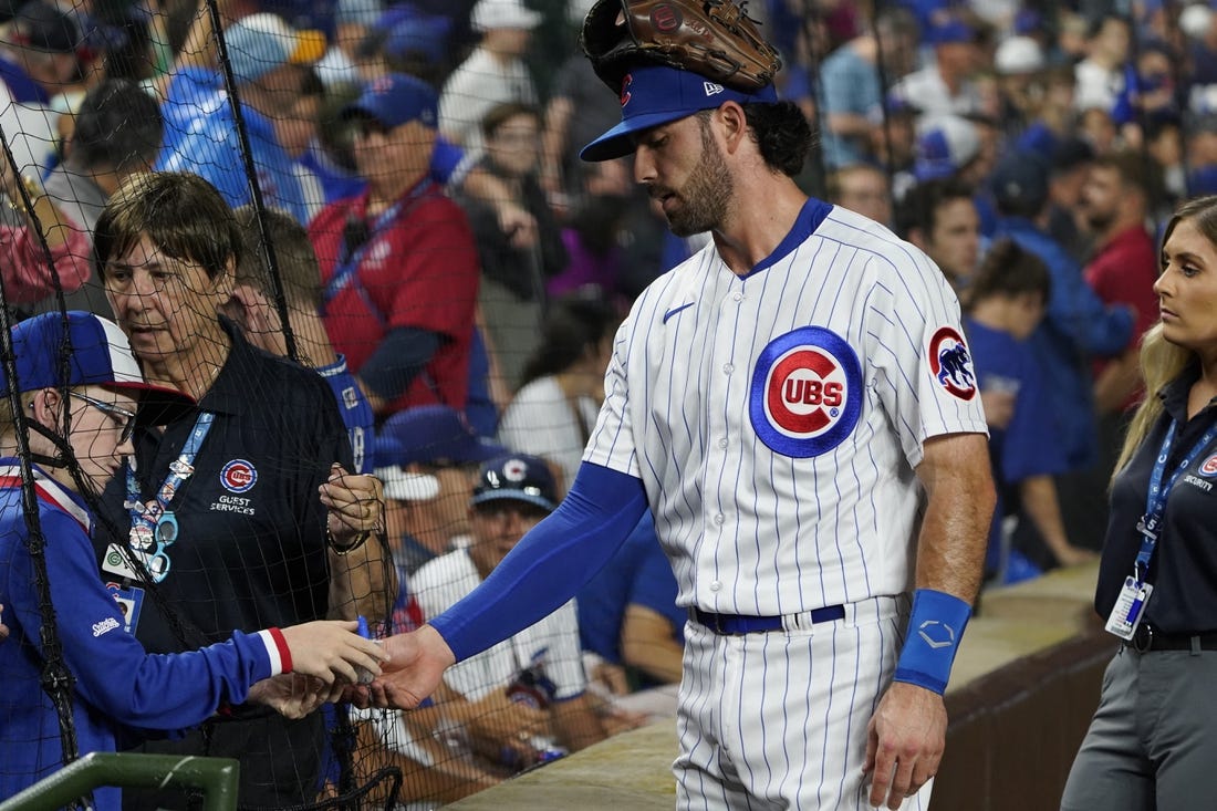 Jul 1, 2023; Chicago, Illinois, USA; Chicago Cubs shortstop Dansby Swanson (7) signs an autograph before the game between the Chicago Cubs and the Cleveland Guardians at Wrigley Field. Mandatory Credit: David Banks-USA TODAY Sports