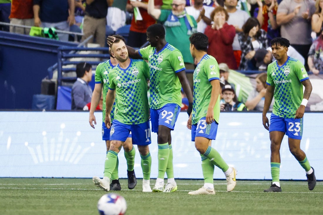 Jul 1, 2023; Seattle, Washington, USA; Seattle Sounders FC midfielder Albert Rusnak (11) celebrates with midfielder defender Abdoulaye Cissoko (92) after scoring a goal against the Houston Dynamo during the second half at Lumen Field. Seattle Sounders FC midfielder Leo Chu (23), right, walking back to midfield, assisted on the goal. Mandatory Credit: Joe Nicholson-USA TODAY Sports