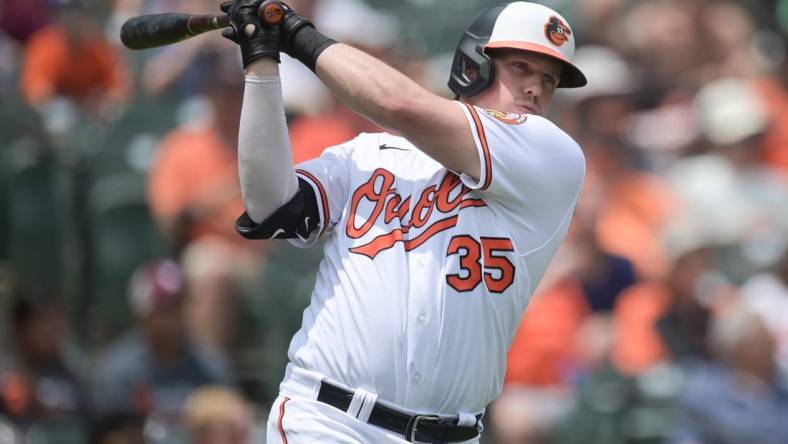 Jul 2, 2023; Baltimore, Maryland, USA;  Baltimore Orioles catcher Adley Rutschman (35) swings while standing by the on-deck circle during the third inning of the game against the Minnesota Twins  at Oriole Park at Camden Yards. Mandatory Credit: Tommy Gilligan-USA TODAY Sports