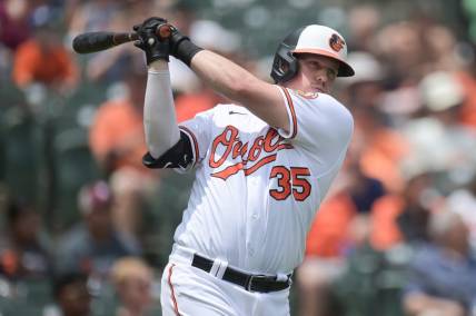 Jul 2, 2023; Baltimore, Maryland, USA;  Baltimore Orioles catcher Adley Rutschman (35) swings while standing by the on-deck circle during the third inning of the game against the Minnesota Twins  at Oriole Park at Camden Yards. Mandatory Credit: Tommy Gilligan-USA TODAY Sports