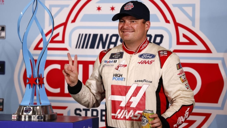 Jul 2, 2023; Chicago, Illinois, USA;  Xfinity Series driver Cole Custer (00) poses with the race trophy after the race was canceled by NASCAR due to flooding for The Loop 121 of the Chicago Street Race. Mandatory Credit: Mike Dinovo-USA TODAY Sports