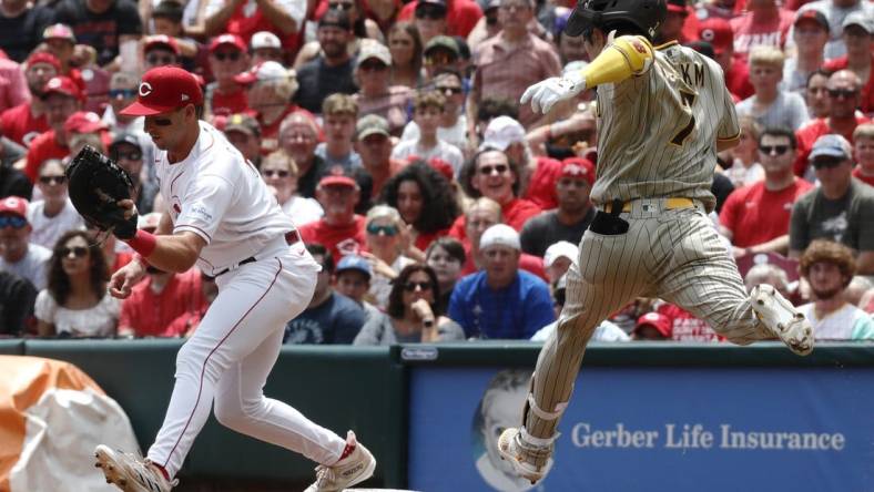 Jul 2, 2023; Cincinnati, Ohio, USA; San Diego Padres second baseman Ha-Seong Kim (7) is out at first against Cincinnati Reds first baseman Spencer Steer (left) during the third inning at Great American Ball Park. Mandatory Credit: David Kohl-USA TODAY Sports