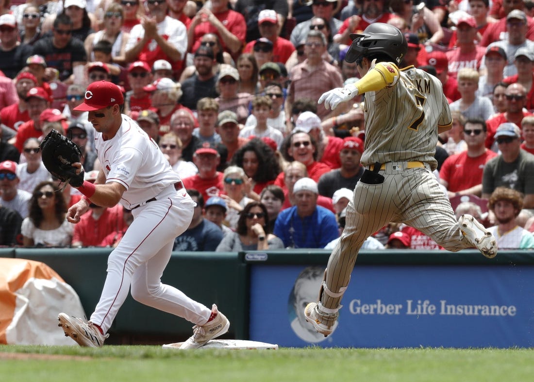 Jul 2, 2023; Cincinnati, Ohio, USA; San Diego Padres second baseman Ha-Seong Kim (7) is out at first against Cincinnati Reds first baseman Spencer Steer (left) during the third inning at Great American Ball Park. Mandatory Credit: David Kohl-USA TODAY Sports