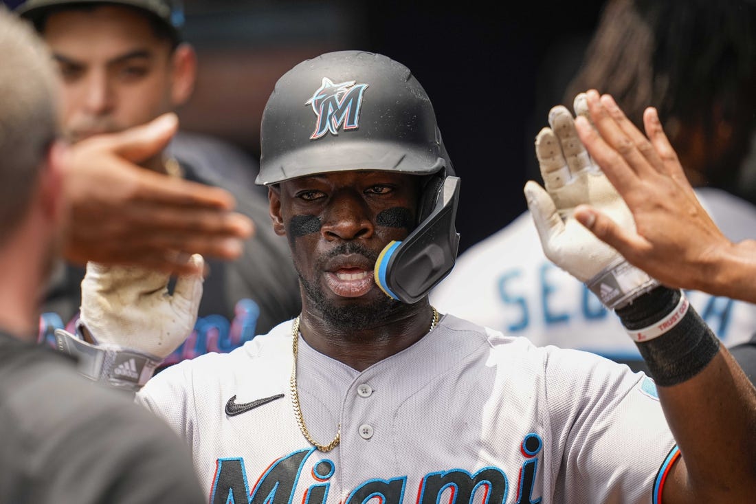 Jul 2, 2023; Cumberland, Georgia, USA; Miami Marlins center fielder Jonathan Davis (49) gets high fives after scoring a run against the Atlanta Braves during the second inning at Truist Park. Mandatory Credit: Dale Zanine-USA TODAY Sports