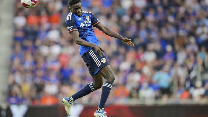 Jun 21, 2023; Cincinnati, Ohio, USA;  FC Cincinnati forward Dominique Badji (14) heads the ball against Toronto FC in the first half at TQL Stadium. Mandatory Credit: Aaron Doster-USA TODAY Sports