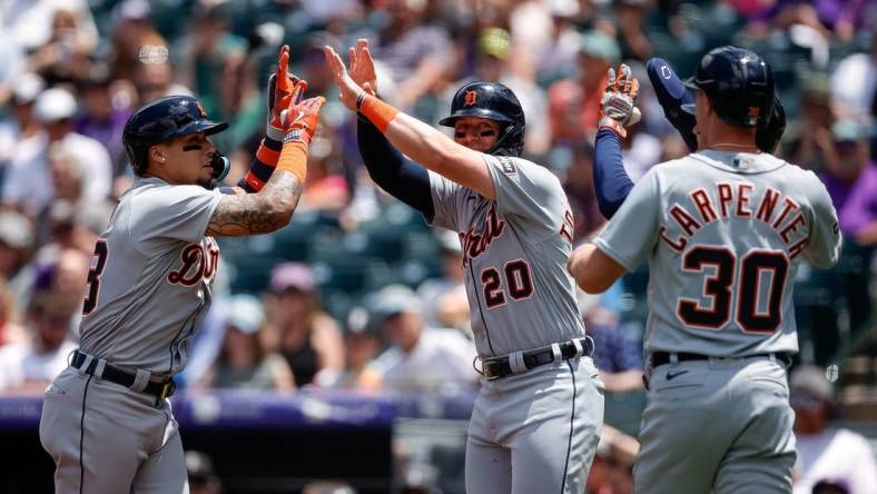 Jul 2, 2023; Denver, Colorado, USA; Detroit Tigers shortstop Javier Baez (28) celebrates his grand slam with first baseman Spencer Torkelson (20) and designated hitter Zach McKinstry (39) and right fielder Kerry Carpenter (30) in the first inning against the Colorado Rockies at Coors Field. Mandatory Credit: Isaiah J. Downing-USA TODAY Sports