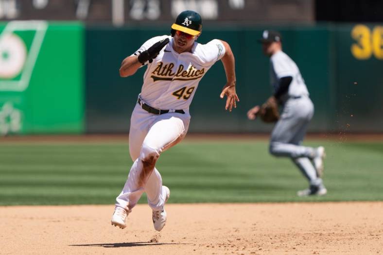Jul 2, 2023; Oakland, California, USA;  Oakland Athletics first baseman Ryan Noda (49) runs during the fifth inning against the Chicago White Sox at Oakland-Alameda County Coliseum. Mandatory Credit: Stan Szeto-USA TODAY Sports