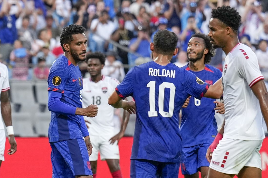 Jul 2, 2023; Charlotte, North Carolina, USA; United States midfielder Cristian Roldan (10) congratulates forward Jesus Ferreira (9) after his goal against the Trinidad and Tobago during the first half at Bank of America Stadium. Mandatory Credit: Jim Dedmon-USA TODAY Sports