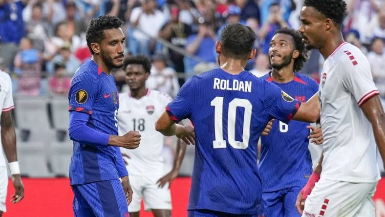 Jul 2, 2023; Charlotte, North Carolina, USA; United States midfielder Cristian Roldan (10) congratulates forward Jesus Ferreira (9) after his goal against the Trinidad and Tobago during the first half at Bank of America Stadium. Mandatory Credit: Jim Dedmon-USA TODAY Sports