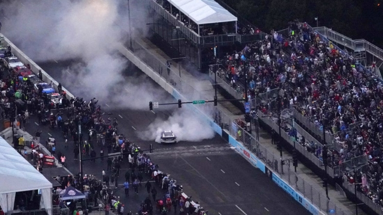 Jul 2, 2023; Chicago, Illinois, USA; NASCAR Cup Series driver Shane Van Gisbergen (91) does a burn out after winning the Grant Park 220 of the Chicago Street Race viewed from the NEMA Chicago buliding. Mandatory Credit: Jon Durr-USA TODAY Sports