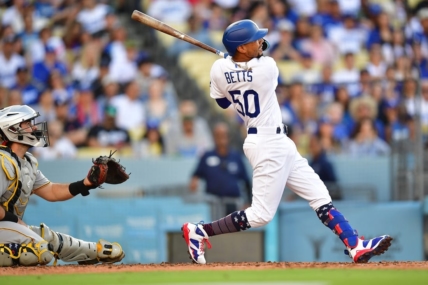 July 4, 2023; Los Angeles, California, USA; Los Angeles Dodgers second baseman Mookie Betts (50) hits a solo home run against the Pittsburgh Pirates during the second inning at Dodger Stadium. Mandatory Credit: Gary A. Vasquez-USA TODAY Sports