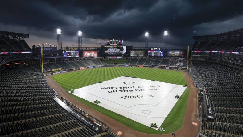 Jul 5, 2023; Chicago, Illinois, USA; A tarp covers the infield during a rain delay before a game between the Chicago White Sox and Toronto Blue Jays at Guaranteed Rate Field. Mandatory Credit: Kamil Krzaczynski-USA TODAY Sports