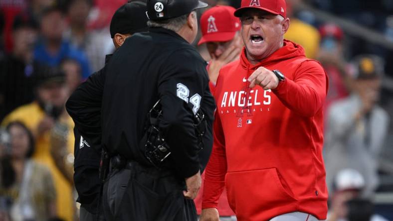 Jul 5, 2023; San Diego, California, USA; Los Angeles Angels manager Phil Nevin (right) argues with home plate umpire Jerry Layne (24) during the seventh inning at Petco Park. Mandatory Credit: Orlando Ramirez-USA TODAY Sports