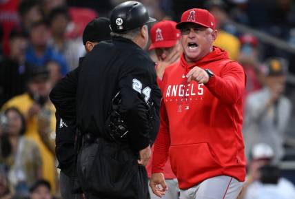 Jul 5, 2023; San Diego, California, USA; Los Angeles Angels manager Phil Nevin (right) argues with home plate umpire Jerry Layne (24) during the seventh inning at Petco Park. Mandatory Credit: Orlando Ramirez-USA TODAY Sports