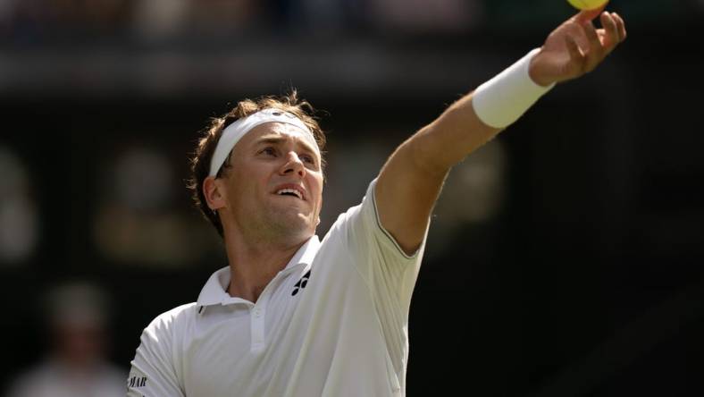 Jul 6, 2023; London, United Kingdom; Casper Ruud (NOR) tosses the ball to serve during his match against Liam Broady (GBR) on day four at the All England Lawn Tennis and Croquet Club.  Mandatory Credit: Susan Mullane-USA TODAY Sports