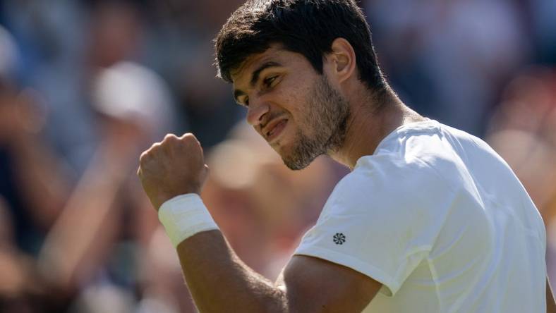 Jul 7, 2023; London, United Kingdom; Carlos Alcaraz (ESP) celebrates winning his match against Alexandre Muller (FRA) on day five of Wimbledon at the All England Lawn Tennis and Croquet Club.  Mandatory Credit: Susan Mullane-USA TODAY Sports